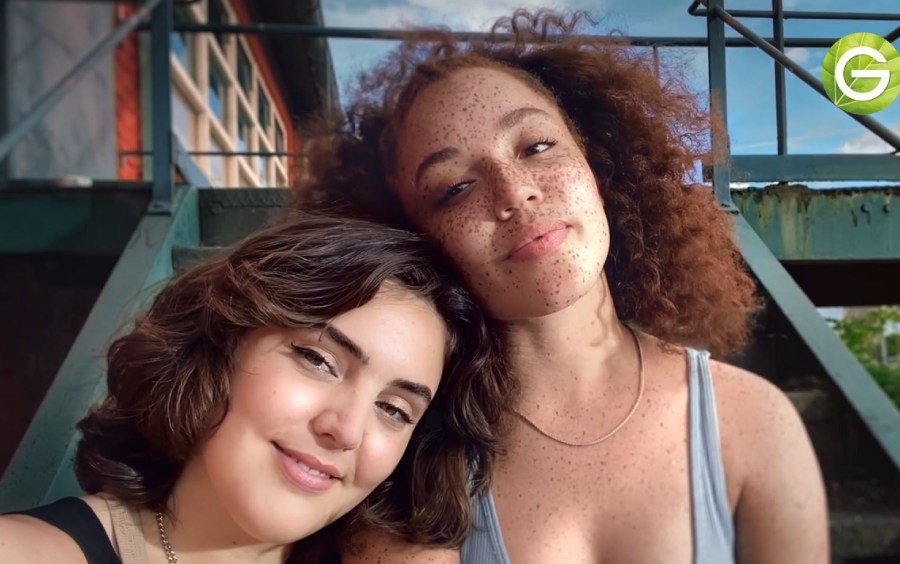 Portrait of two women smiling on steel stairs